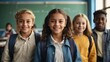 © VistaVisions - Portrait of cheerful smiling diverse schoolchildren standing posing in classroom looking at camera happy after school reopens. Diversity back to school concept