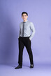 © 1112000 - Portrait of Asian male businessman standing and posing on purple background