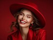 © hakule - A woman wearing a red hat and red dress is smiling