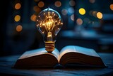 Fototapeta Do akwarium - Illuminated lightbulb above open book symbolizing inspiration education and innovation. Concept Education, Inspiration, Innovation, Lightbulb Symbolism