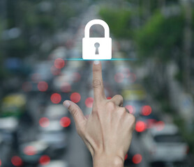 Wall Mural - Hand pressing padlock flat icon over blur of rush hour with cars and road in city, Technology internet security and safety online concept