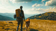 A man hiking together with his dog in the mountains in the vacation trip weekend. Enjoying walking in the beautiful nature landscape. Trekking, tourism, active lifestyle equipment. Back view
