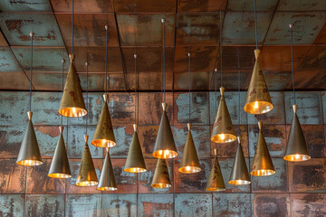 Canvas Print - A vintage-inspired ceiling with distressed copper tiles, accented by a cluster of stylish metallic hanging cone lamps in varying shades of bronze and gold, casting a warm, inviting glow.