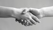© MAY - Cooperation: Two hands coming together in a handshake