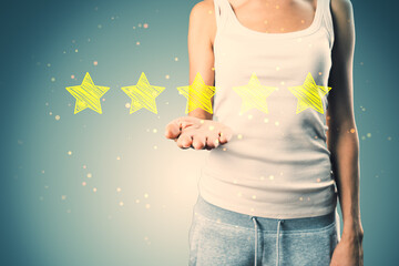 Poster - Casual young woman hand holding 5 star rating on concrete wall background. Customer service and excellent feedback.