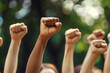 © Stock'd  - young diverse people protesting with raised fists and arms and blurred background, no faces
