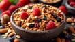 Homemade granola with fresh berries and nuts in bowl, closeup