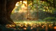 A swing is hanging from a tree in a park. The swing is empty and the tree is surrounded by grass. The scene is peaceful and serene, with the sunlight shining through the leaves of the tree