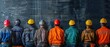 A group of construction workers wearing hard hats stand in a line. The workers are wearing different colored jackets, including orange, green, and blue. Concept of unity and teamwork among the workers