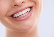 © Tasneem/peopleimages.com - Teeth, mouth and woman with smile for dental, health and orthodontics with skin on white background. Oral hygiene, closeup for wellness and happy with veneers, dentist treatment and shine in studio