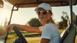 Woman in golf cart, wearing sunglasses, on a golf course