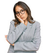 © Krakenimages.com - Young brunette woman wearing business clothes thinking looking tired and bored with depression problems with crossed arms.