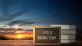 Fototapeta Sawanna - World book days concept, pile of books with text and beautiful sunset  landscape view as background.