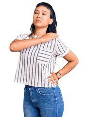 Wall Mural - Young woman wearing casual clothes suffering of neck ache injury, touching neck with hand, muscular pain