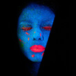 Face, neon and whimsical paint for creative, art and glitter with unique surreal glow. Person, science fiction and color with dream, rave and abstract uv illusion for mystical fluorescent trance
