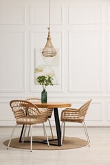 Poster - Dining room interior with comfortable furniture and green branches