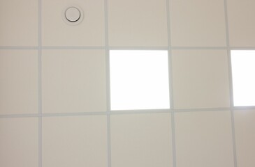 Wall Mural - White ceiling with PVC tiles and lighting, bottom view