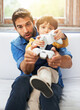 © Duncan M/peopleimages.com - Father, kid or remote to play, gaming or virtual to relax, esports or technology in living room. Dad, child or controller on sofa to teach, fun or challenge as video game, bonding or together