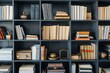 A minimalist bookshelf in an office setting, filled with rows of neatly arranged books of various sizes and colors