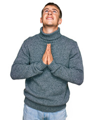 Poster - Young blond man wearing casual clothes begging and praying with hands together with hope expression on face very emotional and worried. begging.