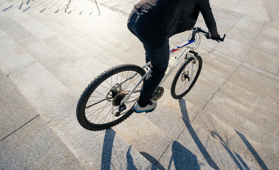 Wall Mural - Woman free rider riding bike going down city stairs