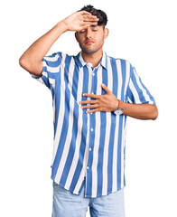 Canvas Print - Young hispanic man wearing casual clothes touching forehead for illness and fever, flu and cold, virus sick