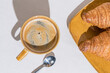 Above view of Morning Coffee and Fresh Croissants on a Textured Background