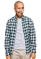 Poster - Hispanic adult man wearing casual clothes winking looking at the camera with sexy expression, cheerful and happy face.