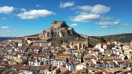 Wall Mural - Aerial view of medieval and historic city, Morella. Ancient walled city located on a hill-top in the province of Castellón, Valencian Community, Spain. Drone going backward. Famous travel destination.