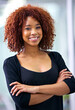Portrait, arms crossed and happy business woman in office at startup company for career or job in South Africa. Face, confidence and smile of creative professional, employee and designer with pride