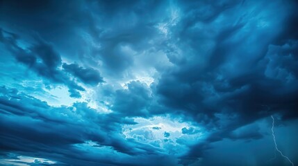 blurred blue sky with clouds the sky has dramatic storms and dark clouds. lightning flashes above th