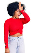 Young african american girl wearing casual clothes and glasses surprised with hand on head for mistake, remember error. forgot, bad memory concept.
