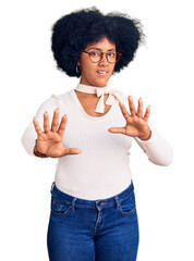 Canvas Print - Young african american girl wearing casual clothes and glasses doing stop gesture with hands palms, angry and frustration expression