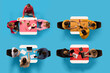 © Lustre Art Group  - Top view of four groups of people engaged in various activities around different colored tables against blue background. Concept of business, leisure time, work, job, meeting, office, friendship. Ad
