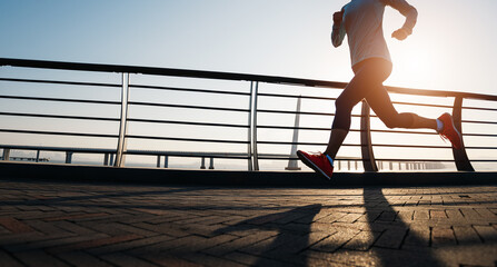 Canvas Print - Fitness woman runner running at seaside