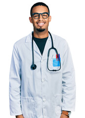 Poster - Young african american man wearing doctor uniform and stethoscope with a happy and cool smile on face. lucky person.