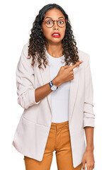 Canvas Print - Young african american girl wearing business clothes pointing aside worried and nervous with forefinger, concerned and surprised expression