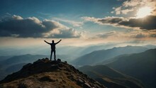 Silhouette Of A Person Standing On The Top Of A Mountain With Arm Towards The Sky Celebrating Their Achievement