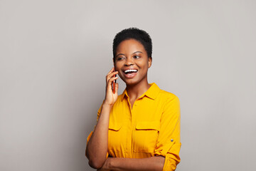 Attractive woman talking by phone on grey banner background