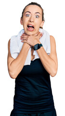 Canvas Print - Young caucasian woman wearing sportswear and towel shouting suffocate because painful strangle. health problem. asphyxiate and suicide concept.