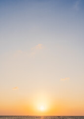 Wall Mural - sunset sky vertical in the evening over sea with golden hour sunlight, horizon sea summer nature bac