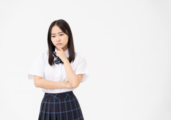 制服を着た日本人女子高校生/考えている/白背景スタジオ撮影	