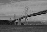 Fototapeta  - grayscale of a San Francisco bridge stretching across a body of water