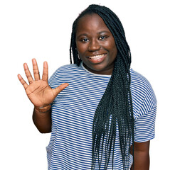 Wall Mural - Young black woman with braids wearing casual clothes showing and pointing up with fingers number five while smiling confident and happy.