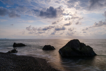 Water waves of the Black Sea crashing on rocks on the stony shore, coast - close up, nobody, no people. Nature, element, landscape