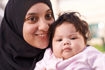 Poster - Muslim, happy and portrait of mother with baby in home for bonding, relationship and calm together. Parenting, family and Islamic mom with newborn infant for love, childcare or support in living room