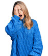 Young blonde woman wearing casual sweater yawning tired covering half face, eye and mouth with hand. face hurts in pain.