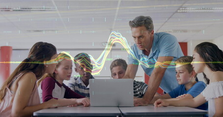 Canvas Print - Image of graph over caucasian male teacher and class of diverse pupils using laptop