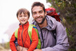 © Mikolette Moller/peopleimages.com - Father, child and portrait with hiking, backpack and travel with smile and happy in nature. Kid, adventure and mountain with love, trust and bonding together with family and journey for holiday