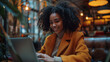 © NaphakStudio - Vibrant co-working scene with young woman with a radiant smile, working on her laptop, embodying the blend of professionalism and modernity.